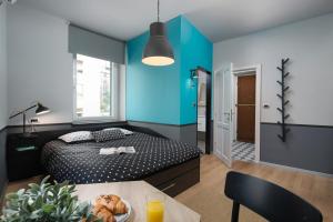 a bedroom with a bed and a table with a plate of food at Studio Apartments River in Rijeka