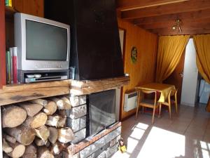a living room with a fireplace with a tv and a fire place at Gîtes La Coquille in Ternuay-Melay-et-Saint-Hilaire