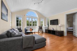 a living room with a couch and a table at Spectacular nature experience at Norway's southern point! in Svenevik