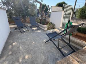 three chairs are sitting on a patio at tata Uccio in Matino