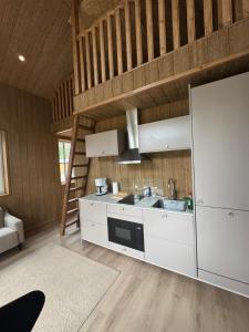 a kitchen with white cabinets and a sink at Hanko Villa Anke & Janne in Hanko