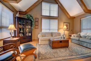 a living room with a couch and a table at Tremblant Prestige - Equinoxe 140-1 in Mont-Tremblant