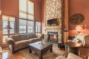 a living room with a couch and a fireplace at Tremblant Prestige - Equinoxe 140-1 in Mont-Tremblant