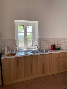 a kitchen with a sink and a window at Matsipeti in Kythira