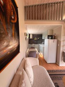 a living room with a couch and a refrigerator at Stugan i Vik på Österlen in Simrishamn +8 photos