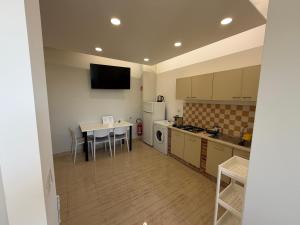a small kitchen with a table and a table and a tableablish at MONTREAL FLAT STUDIO in Reggio di Calabria