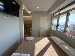 a room with a bed and a flat screen tv at MONTREAL FLAT STUDIO in Reggio di Calabria