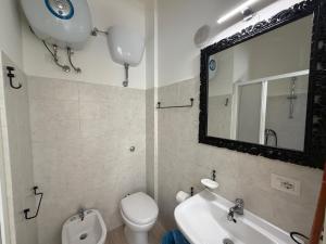 a bathroom with a toilet and a sink and a mirror at MONTREAL FLAT STUDIO in Reggio di Calabria