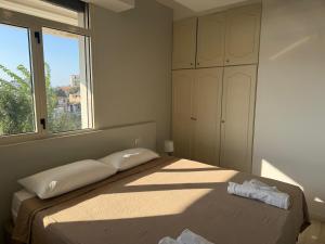 a white bedroom with a bed and a window at MONTREAL FLAT STUDIO in Reggio di Calabria +4 photos