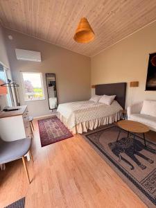 a bedroom with two beds and a table and a couch at Stugan i Vik på Österlen in Simrishamn