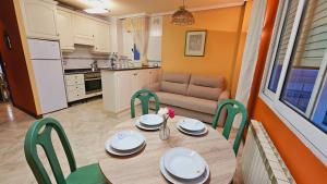 a kitchen with a table and chairs and a couch at Hotel Mataleñas in Santander