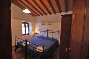 a bedroom with a bed in a room with a window at Agriturismo Villa Opera in Volterra +58 photos