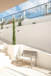a bench sitting on the side of a building at Relax House in Estoril +38 photos