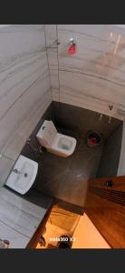 a bathroom with a toilet and a sink at Palazhi Inn in Trivandrum