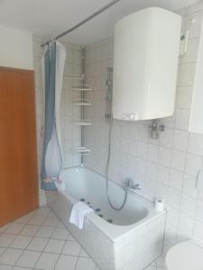 a bath tub in a bathroom with a shower at Werrapark Apart Heubach in Masserberg +9 photos