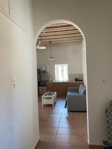 an archway in a living room with a couch at Matsipeti in Kythira +20 photos