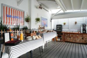 a kitchen with two tables in a room at Cit'Hotel du Cap in Capbreton