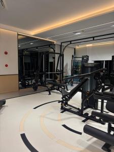 a gym with several treadmills and a mirror at Serenity Naiyang Най Янг D02 in Nai Yang Beach