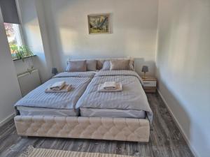 a bedroom with a large bed with two towels on it at MemaFerienwohnung in Gerolstein