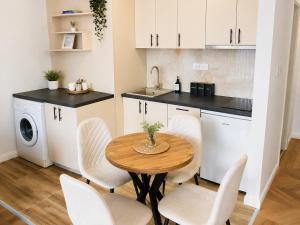 a kitchen and dining room with a table and chairs at Fontana Lux Apartment in Belgrade