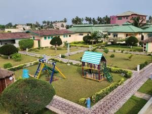 a park with a playground with a play set at Nima Resort et Suites in Mandanou