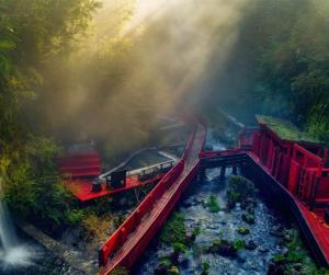 a train on the tracks at a train station at Refugio Barbara - Coñaripe in Coñaripe