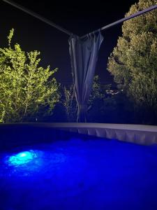 a blue pool at night with trees in the background at Il cielo in una stanza in Itri