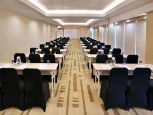a conference room with tables and chairs in it at Mercure Jakarta Simatupang in Jakarta