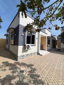 a house with a brick driveway in front of it at Seneu Executive Residence in Mwanza