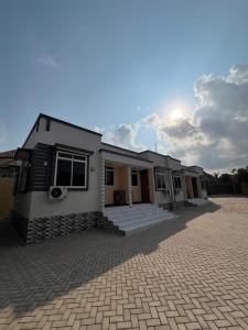 a house with a brick driveway in front of it at Seneu Executive Residence in Mwanza