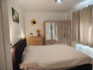 a small bedroom with a bed and a dresser at The nest in Malmedy