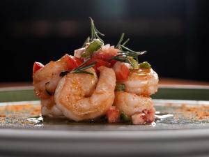 a pile of shrimp on a plate on a table at Mercure Maceio Pajuçara in Maceió