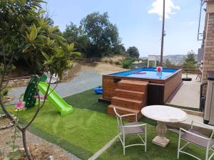 a backyard with a pool table and a playground at Cherry Holiday House in Khandria