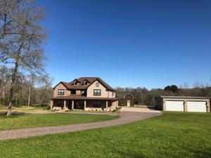 a large house with a driveway and a garage at The Retreat at Hempstead in Hempstead