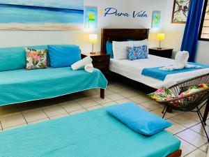 a hotel room with two beds and a chair at Toro Blanco in Coco +234 photos