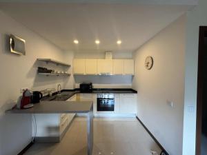 a kitchen with white cabinets and a counter top at Pirin Getaway Heaven in Razlog