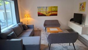 a living room with a couch and a tv at Gula huset in Perstorp