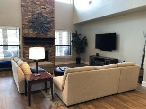 a living room with a couch and a tv at The Retreat at Hempstead in Hempstead
