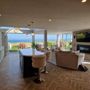 a living room with a couch and a table and chairs at Sunrise view in Ballina