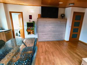 a large sliding door in a room with a wooden floor at Nuestro sueño jurásico in Barreiros