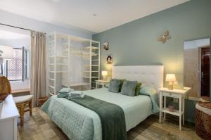 a bedroom with a large bed and two tables at Casa Sherazad in Tías
