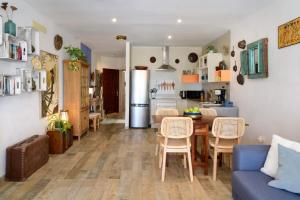 a kitchen and living room with a table and a refrigerator at Casa Sherazad in Tías