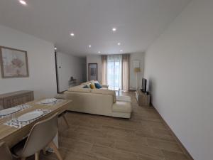 a living room with a couch and a table at La Maison Menhiria in Dol-de-Bretagne