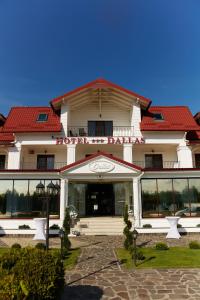 a large white building with a red roof at Hotel Dallas in Negreşti-Oaş