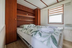 a bedroom with a large bed and a window at 80, Midden in de natuur - Airco! in Oisterwijk