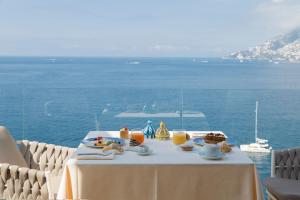 a table with food and drinks on top of the ocean at Hotel Club Due Torri in Maiori +90 photos