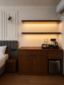 a bedroom with a bed and a wooden cabinet at Aradhana by Nepali in Moratuwa