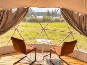 a room with two chairs and a table in a yurt at Trysil Glamping in Trysil +10 photos