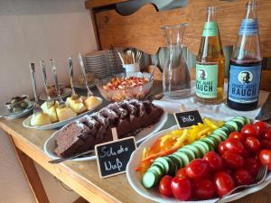 a table with different types of food and bottles of beer at Gästehaus Zunterer in Wallgau