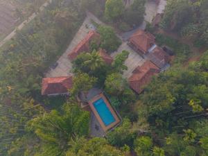 an overhead view of a house with a blue pool at Swastha Royals Wayanad in Kaniyāmbetta